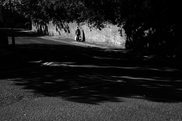 Person carrying shopping in empty street