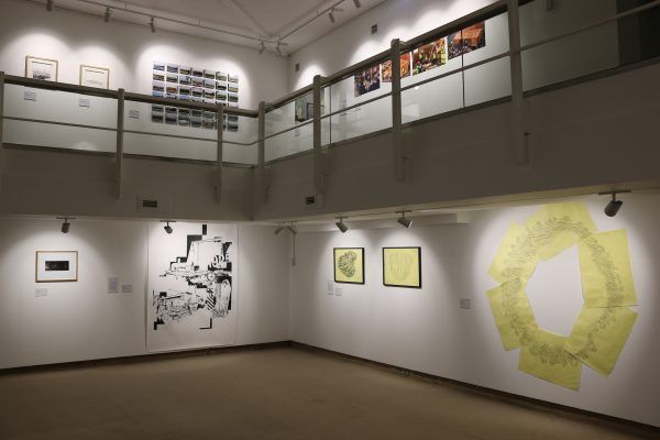 A photograph of an exhibition inside the Peter Scott Gallery with art on white walls.