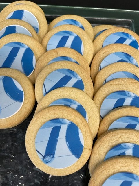 A tray of round biscuits with an edible photo of a mop on them
