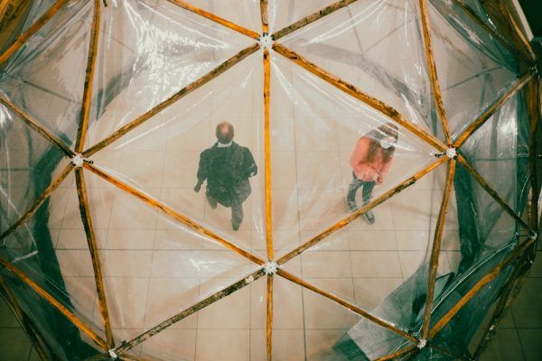 A photo looking down on a pollution pod with Two people in the pod