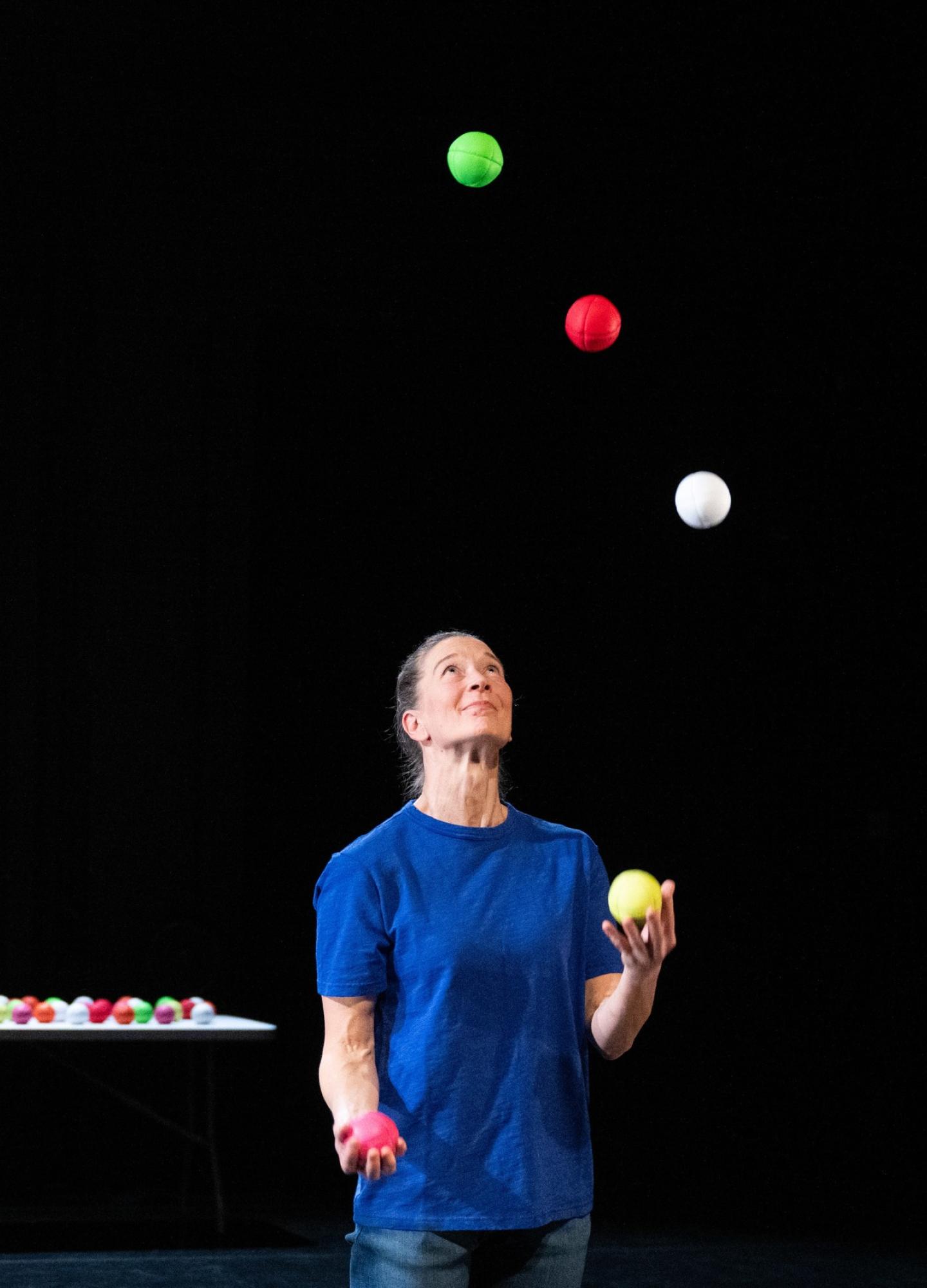 Two people, one of them is juggling