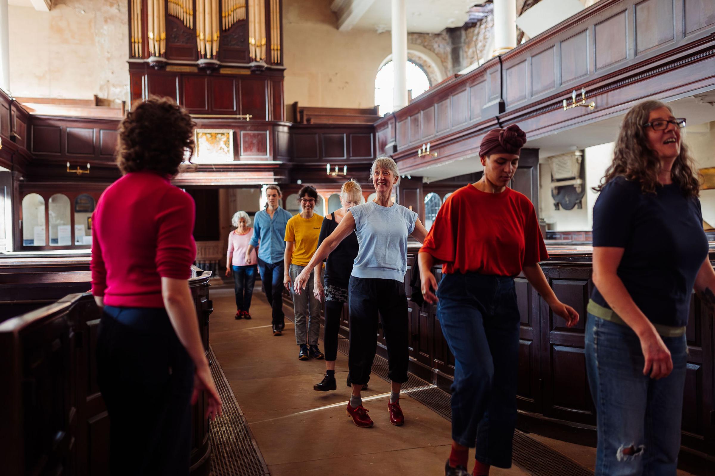 People clog dancing in an old church