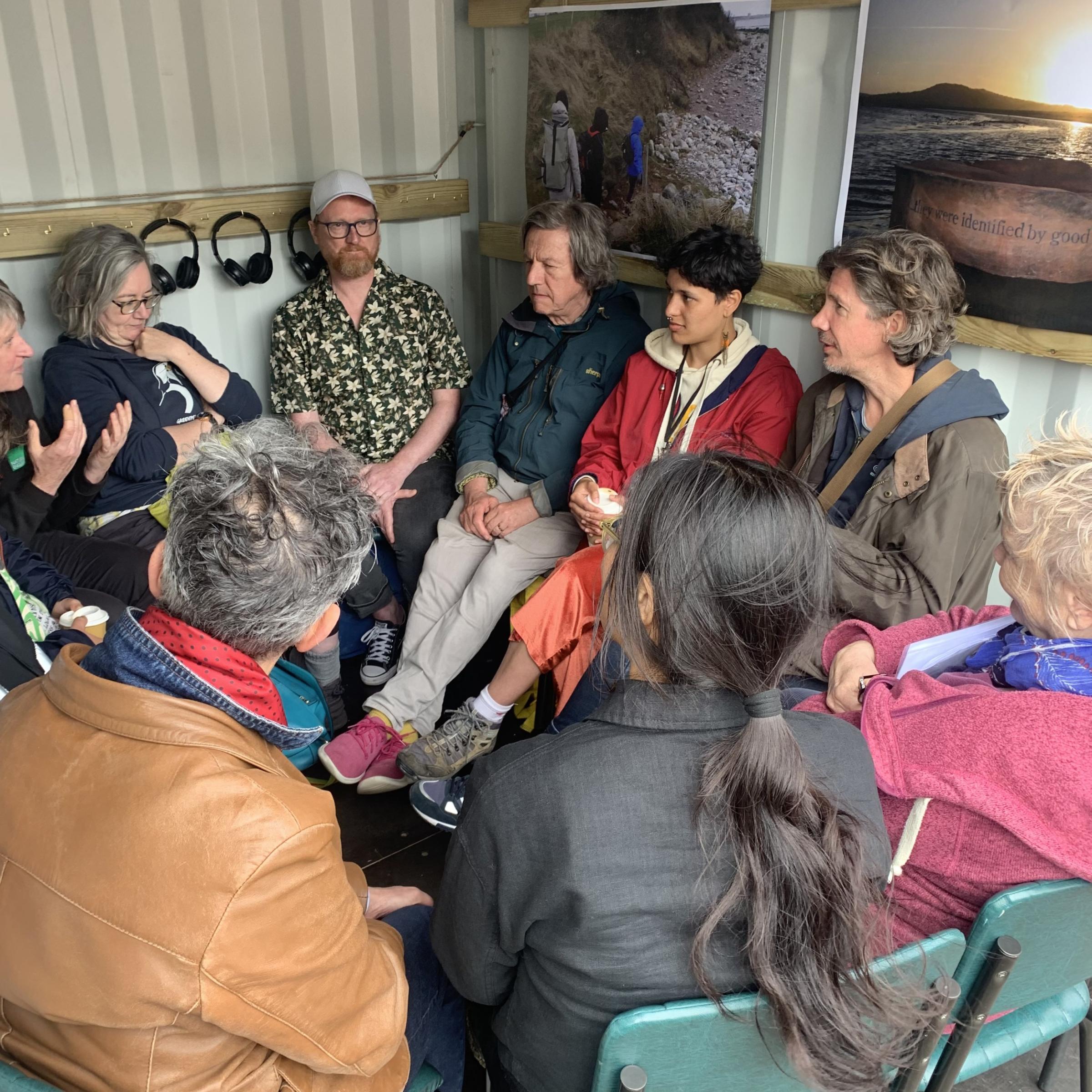 People talking inside a shipping container