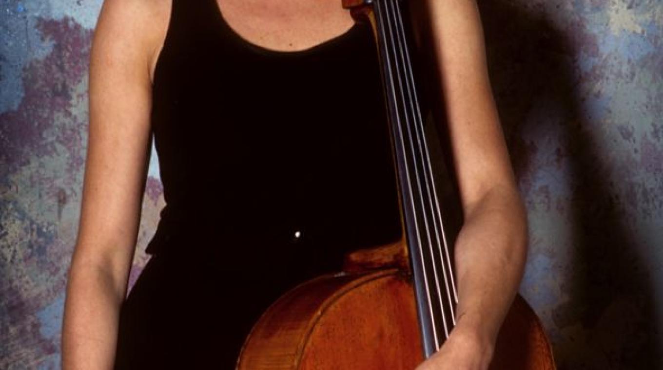Cellist Natalie Clein standing alongside her Cello