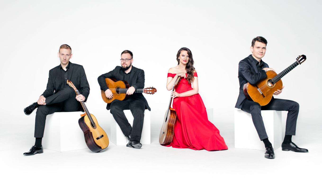 Photo of the Musicians sat down with their guitars.