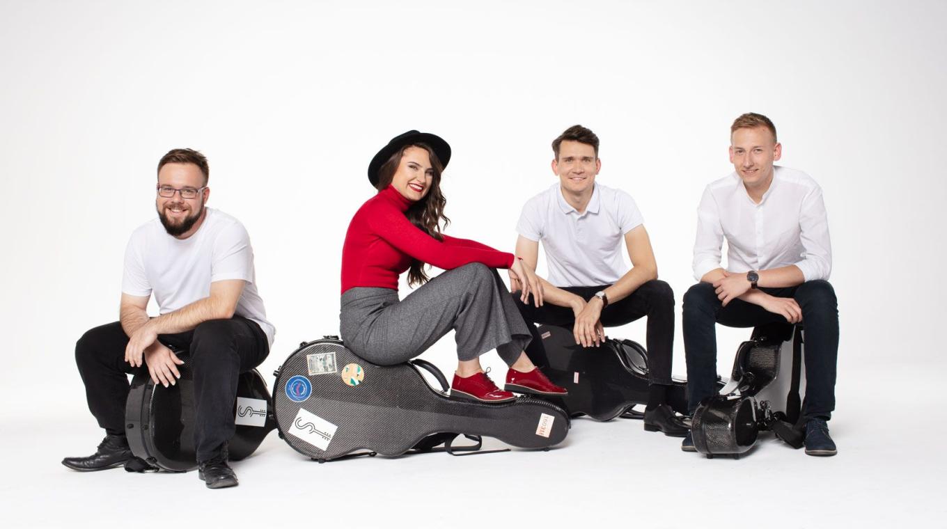 Photo of the Musicians sat on top of their guitar cases.