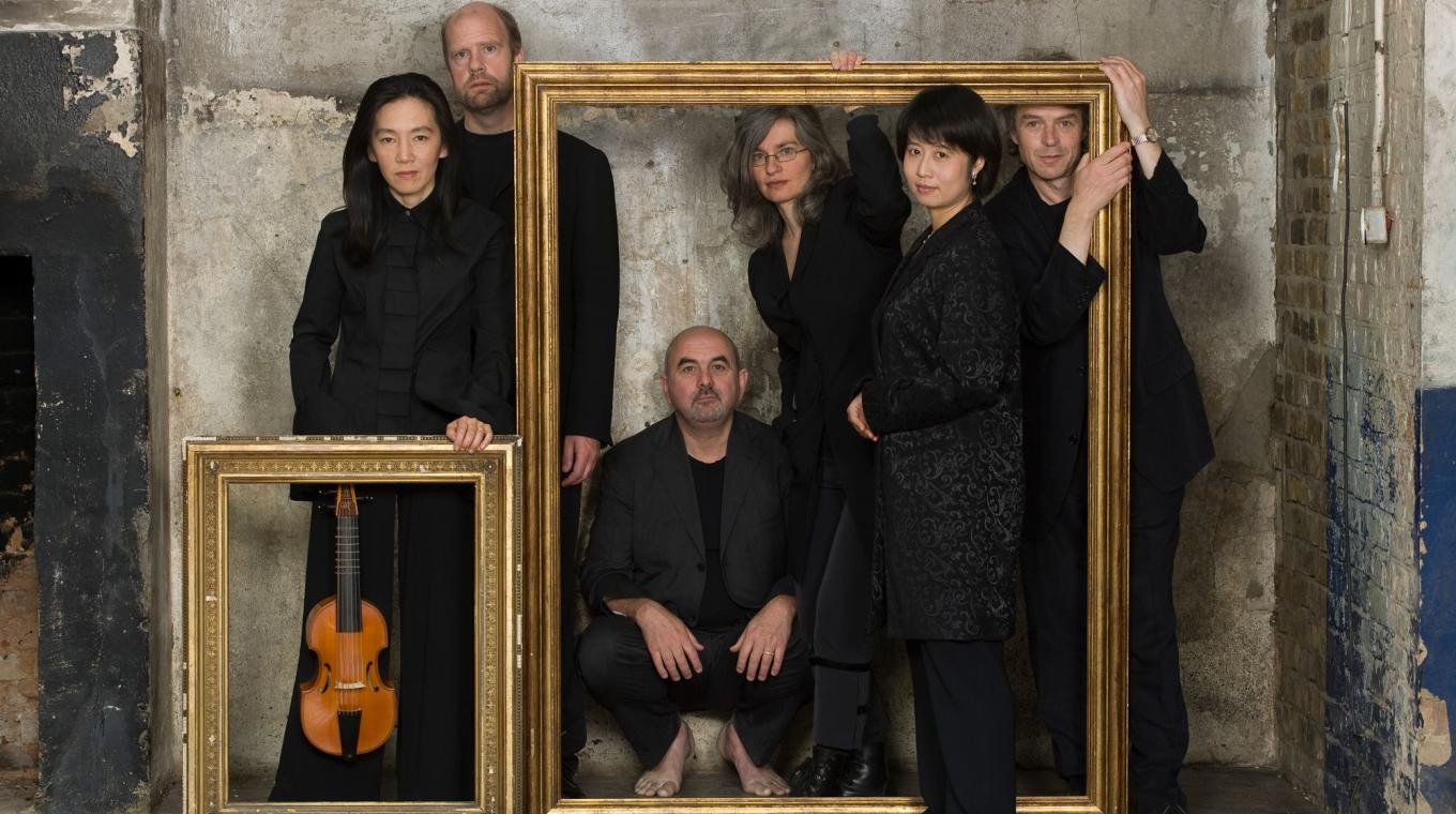 Musicians standing in and around picture frames