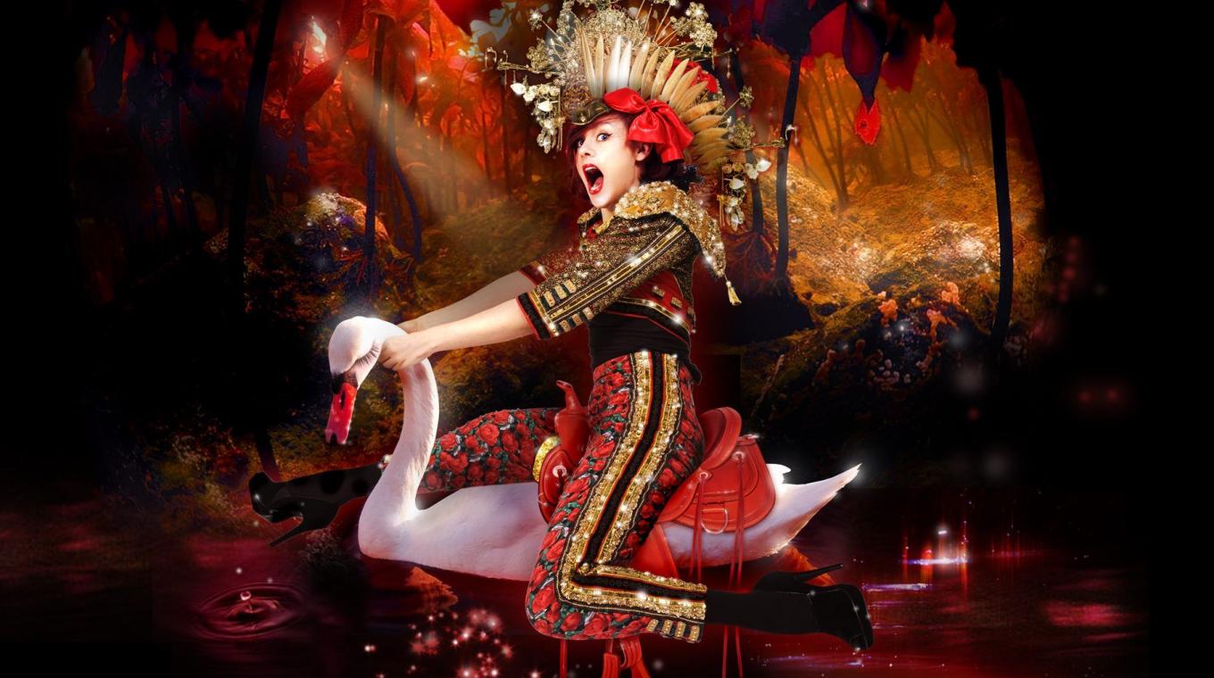 Female Performer in costume sat riding a swan