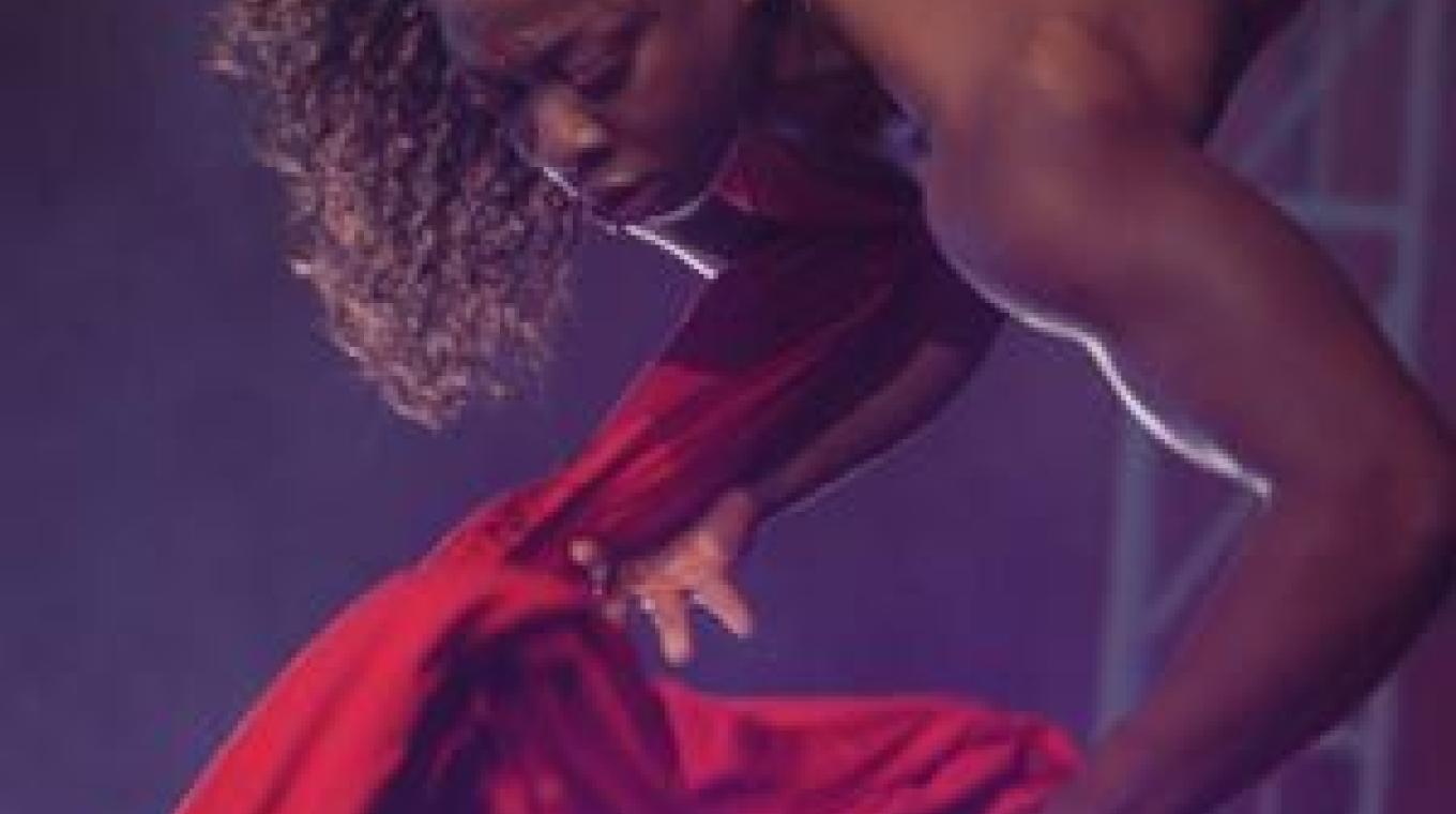 Female Aerialist hanging upside down on stage