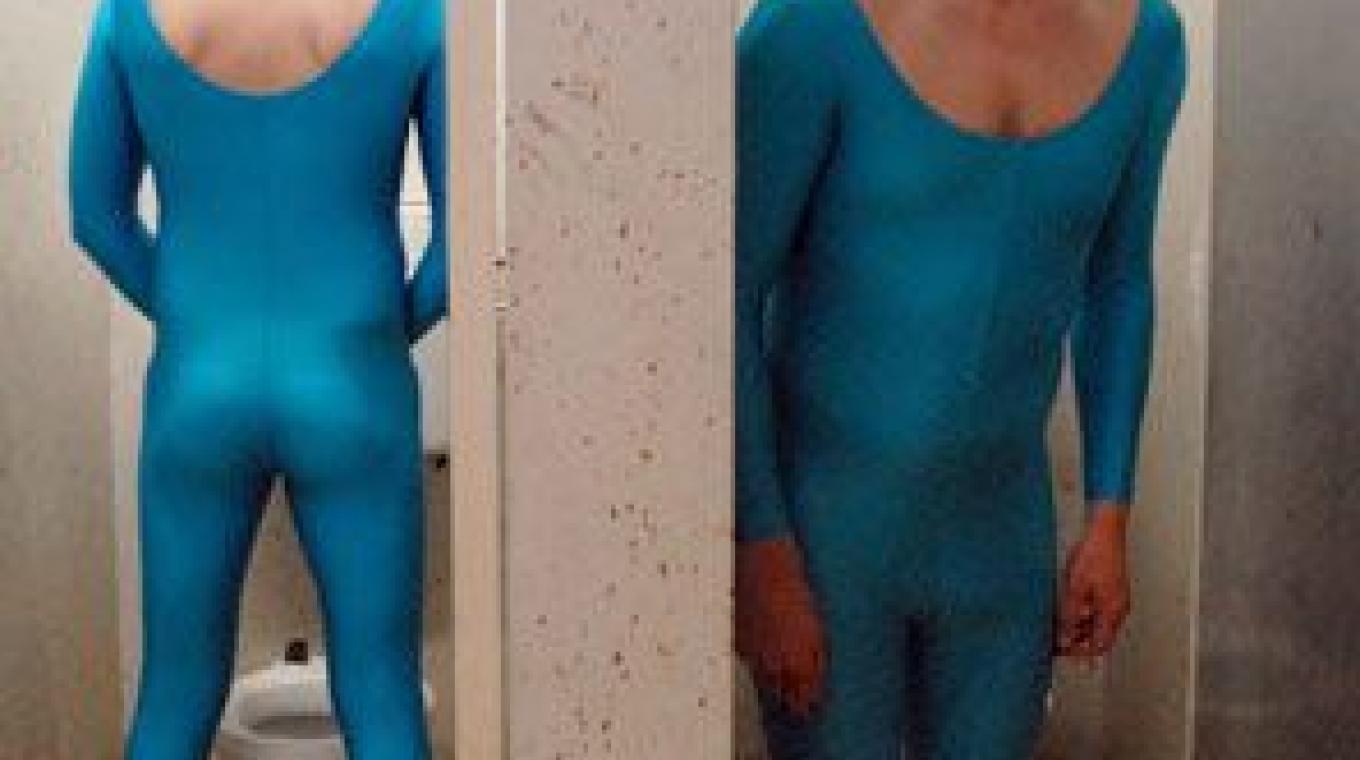 Two men in bright blue leotards in toilet cubicles