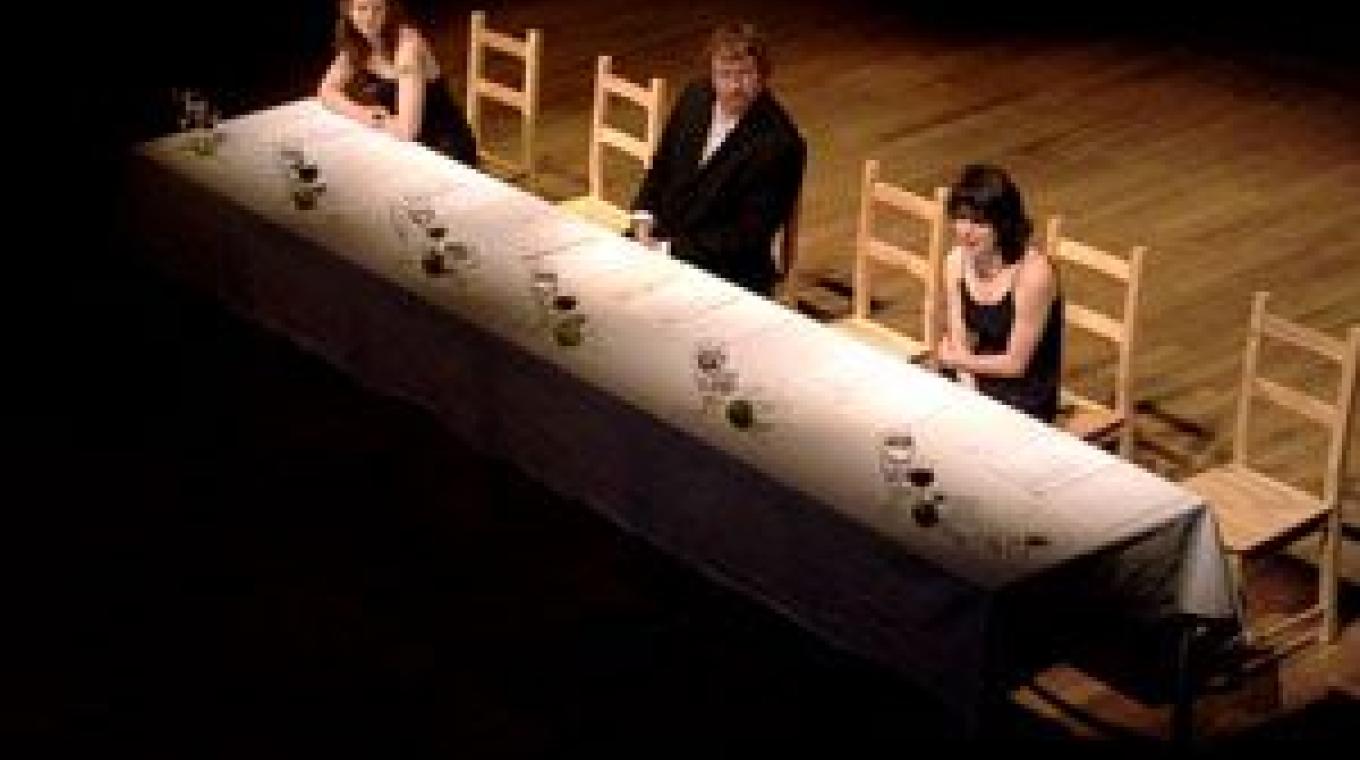 3 performers sat at a long dinner table
