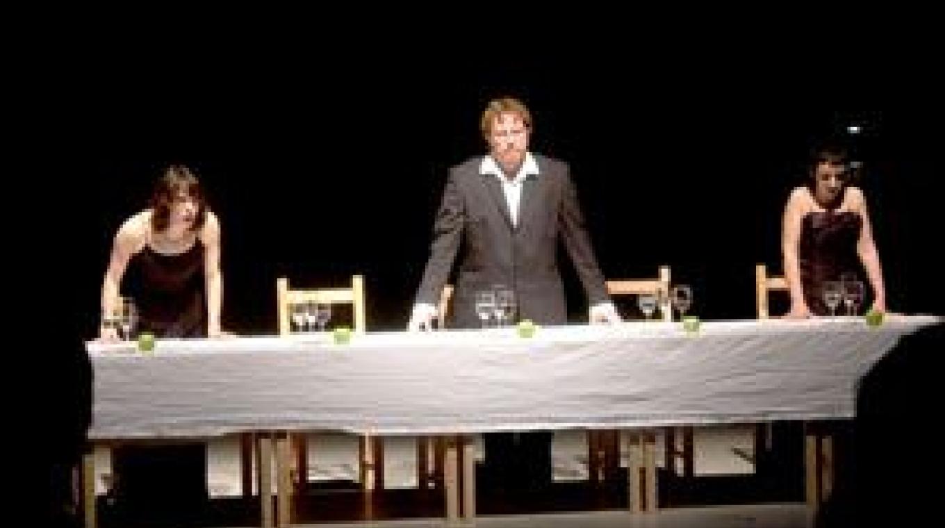 3 Perfomers Stood behind a dinner table