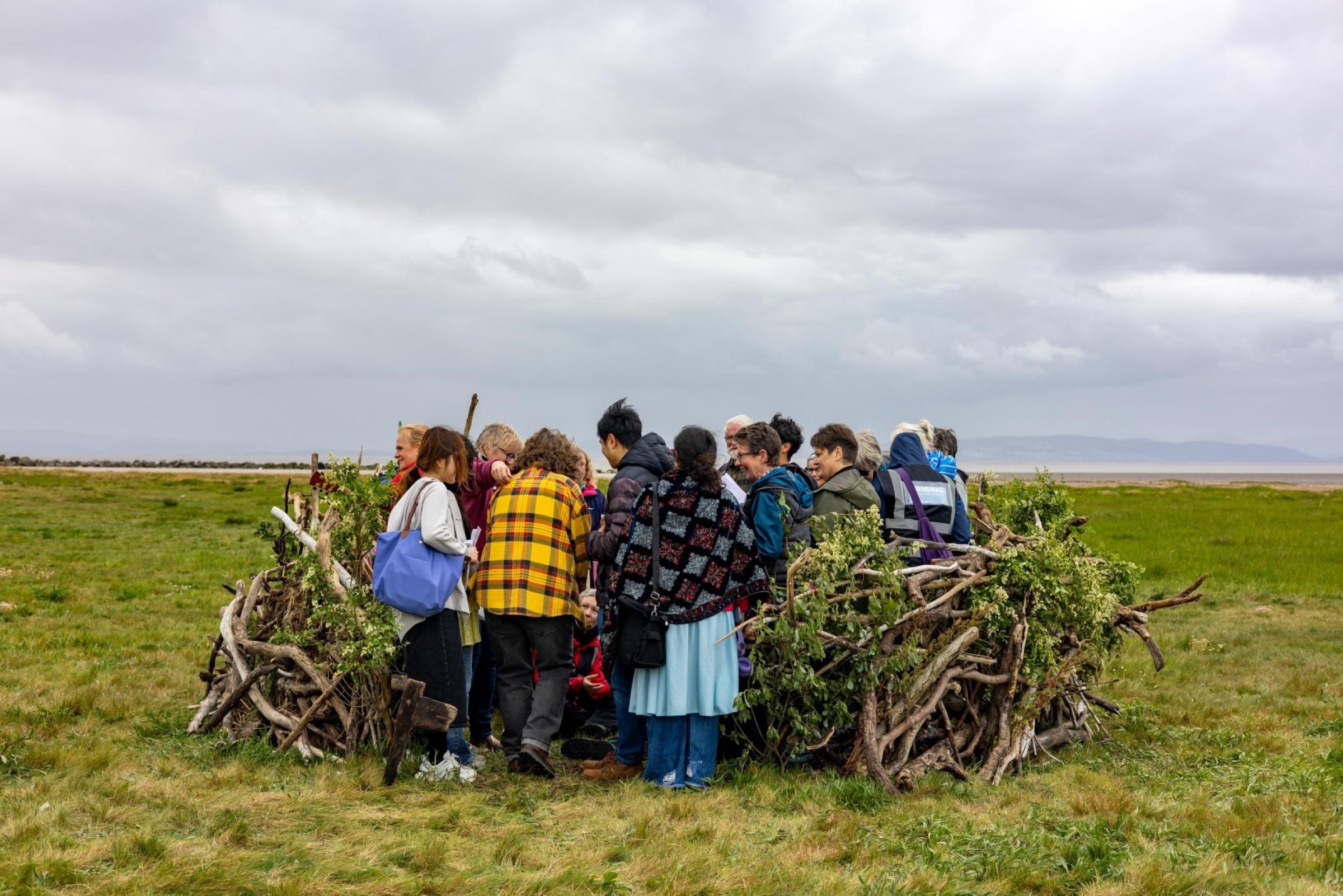 People huddled inside a human sized nest
