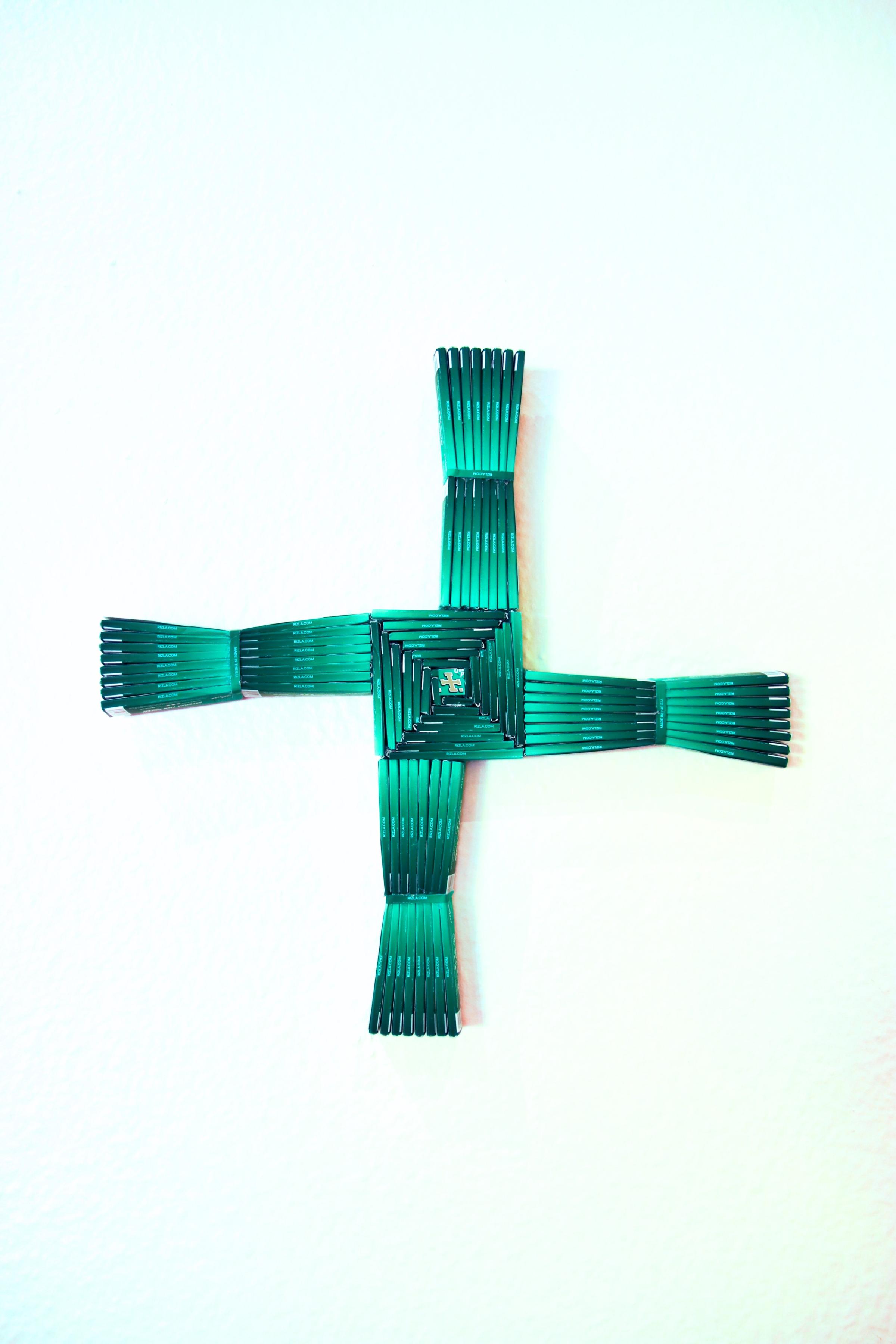 An artwork of a green cross