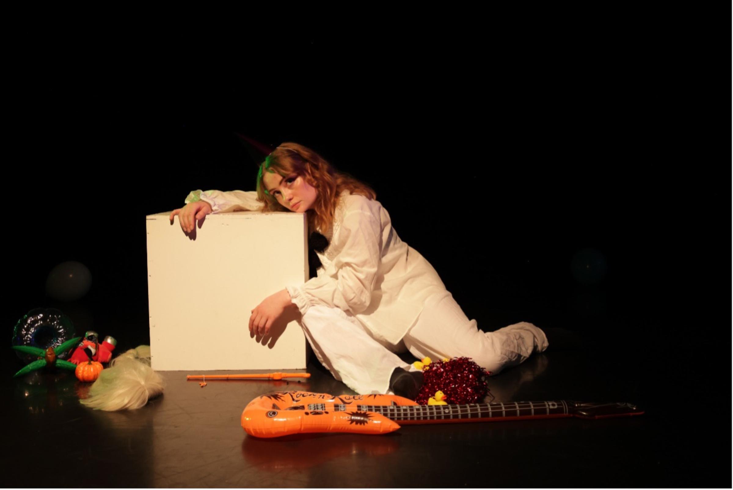 A woman leaning on a box