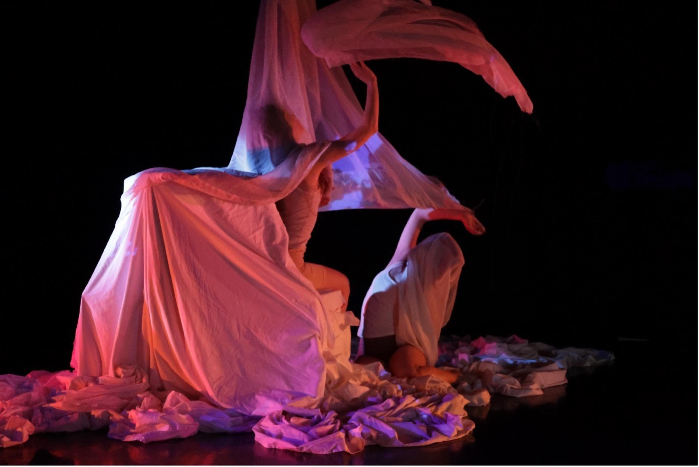 two performers covered in sheets