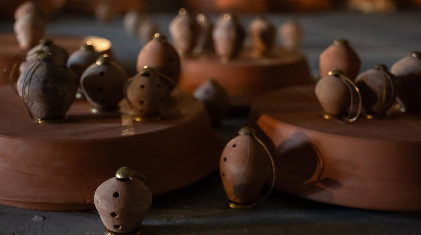 10 small clay pots with holes in and metal attachments