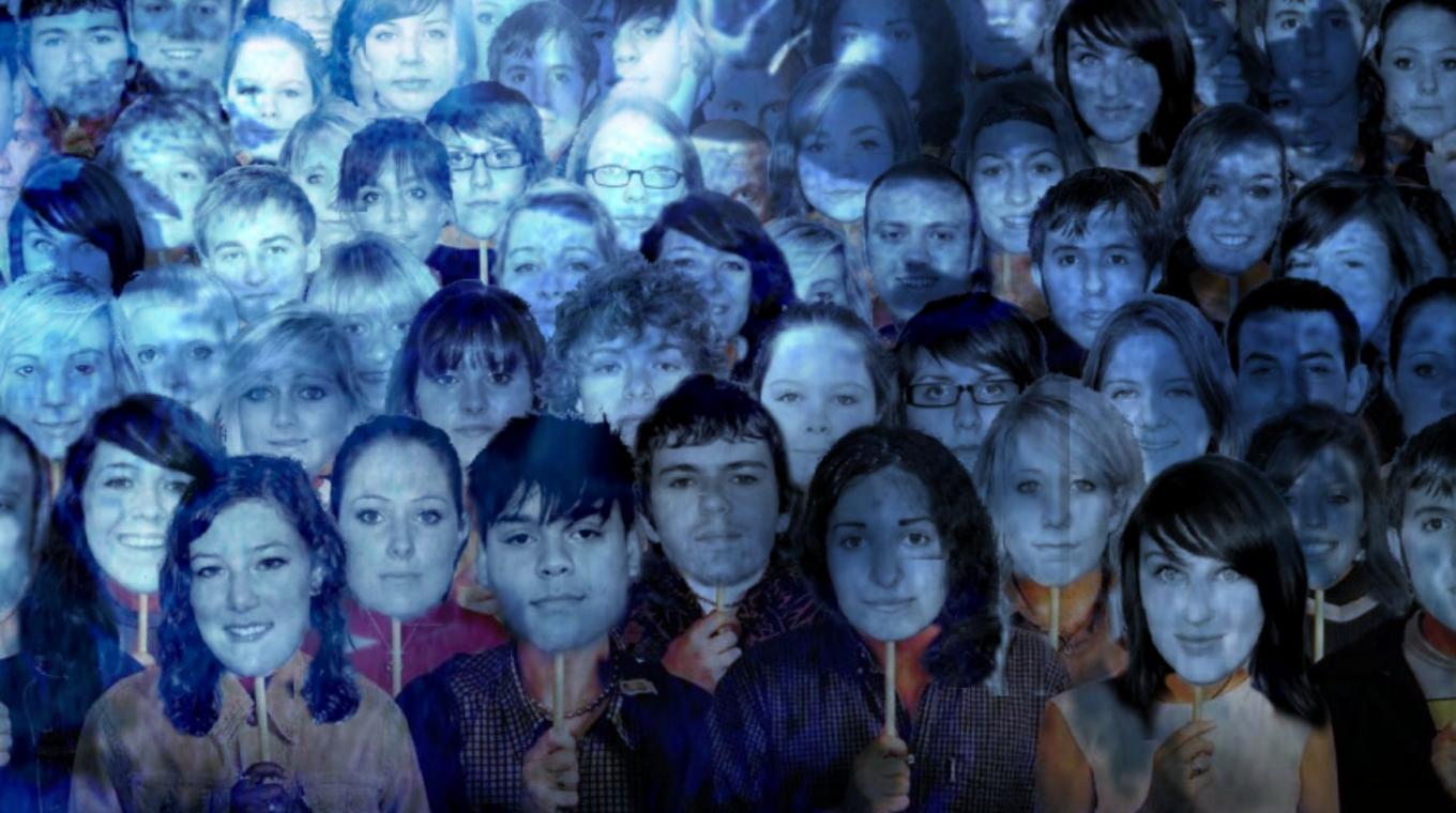 A poster styled as a film poster. Featuring students stood holding head shots of people in front of their own faces