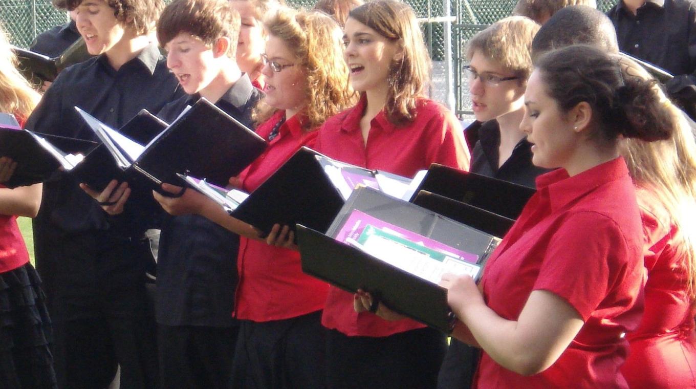 Photo of Choir singing outside.