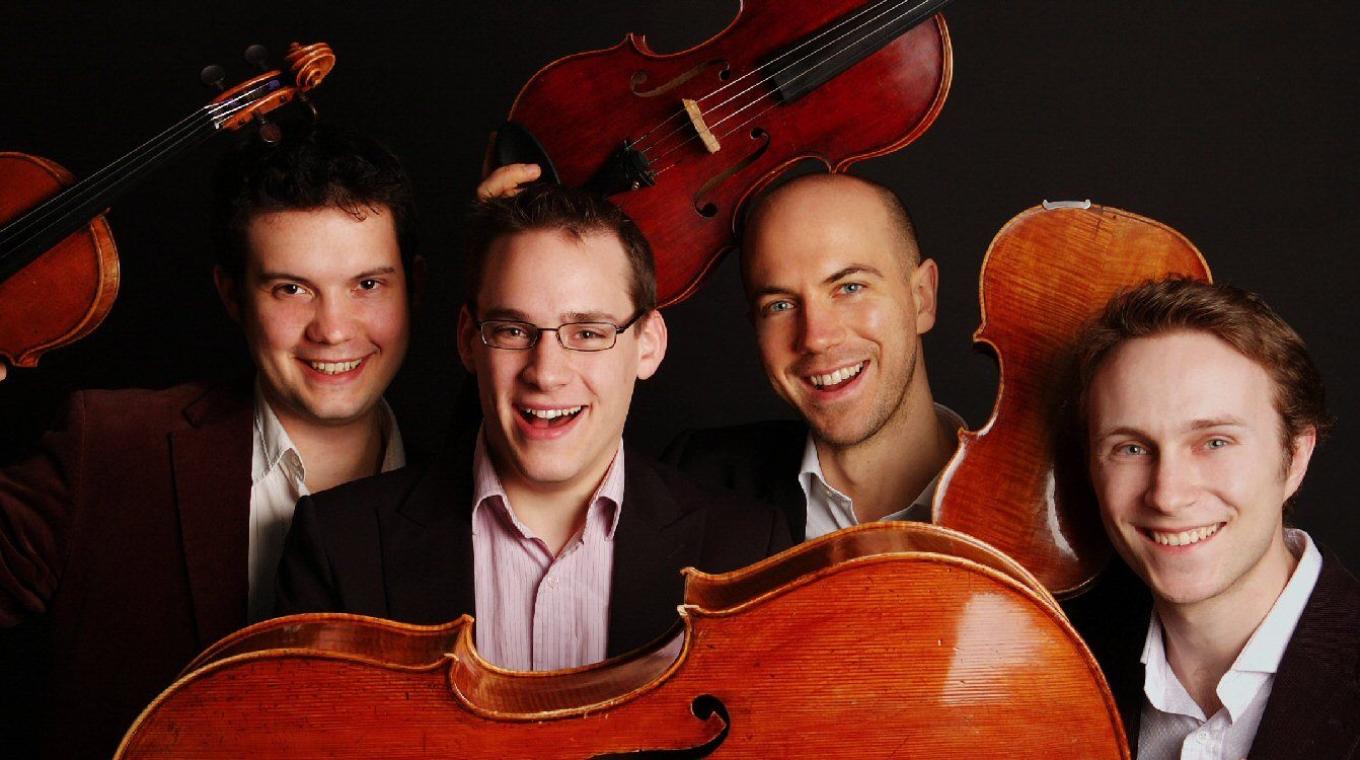 A close up landscape photo of 4 musicians holding their instruments
