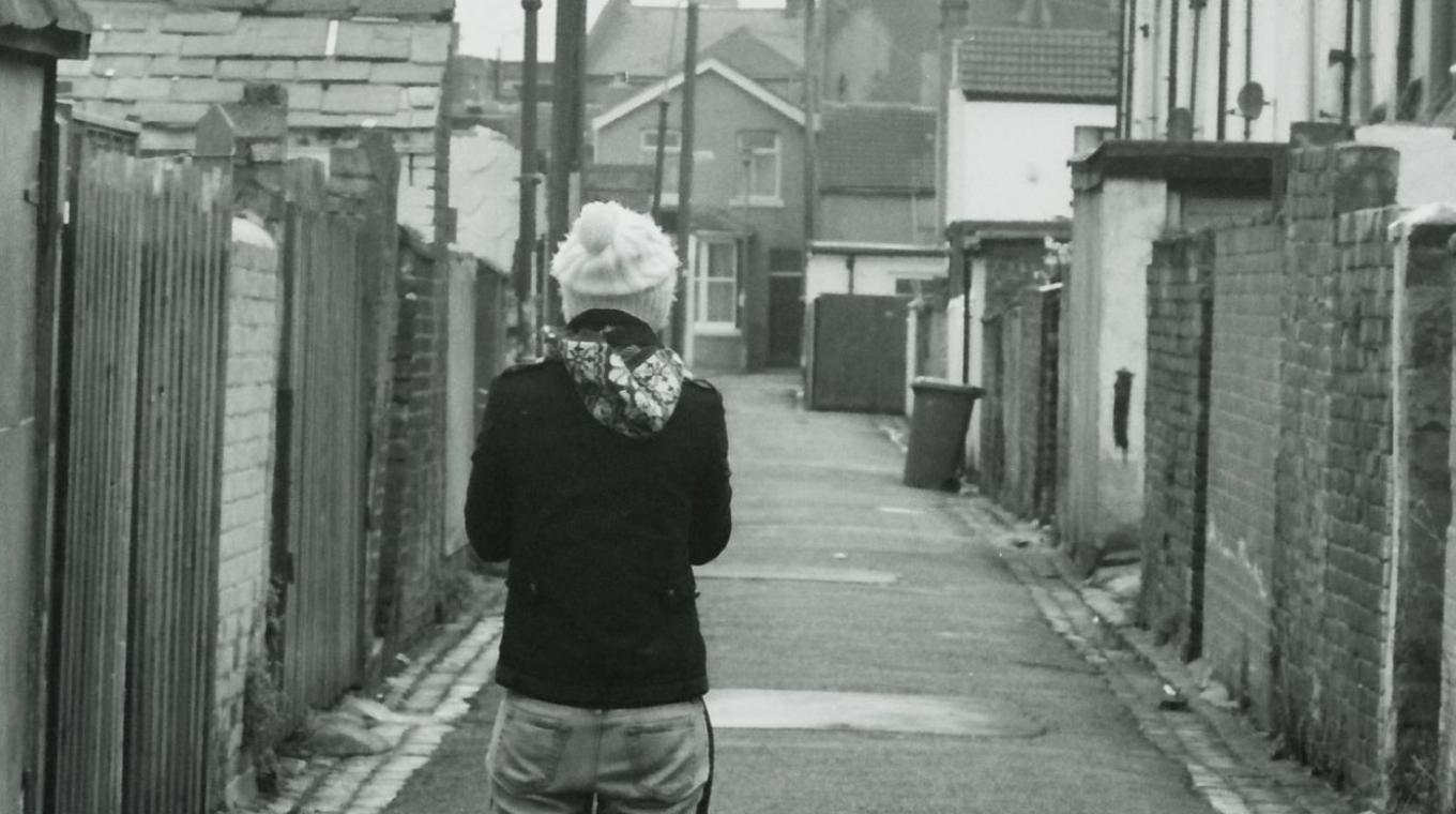 B&W Photo of a person standing in an alley
